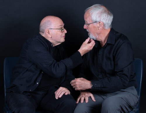 Two older male actors playing King Lear and the Fool act out a scene